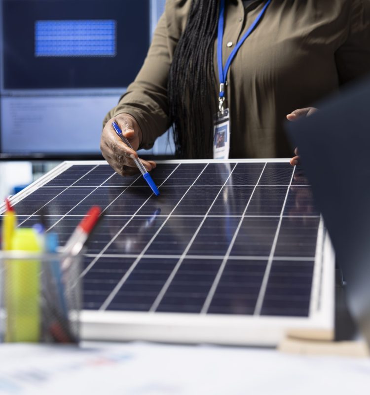 Shareholders meet with industrial plant manager to review solar panel components, analyzing material quality. Photovoltaics factory management executive presents solar panel features to investors